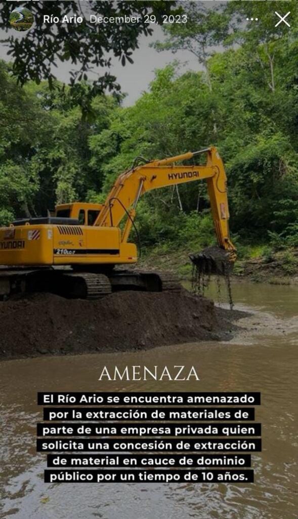 Backhoe digging in the Río Arío riverbed in Costa Rica, highlighting environmental destruction and the urgent threat to local ecosystems.