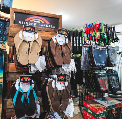 Display of Rainbow Sandals in various styles and colors inside a store.