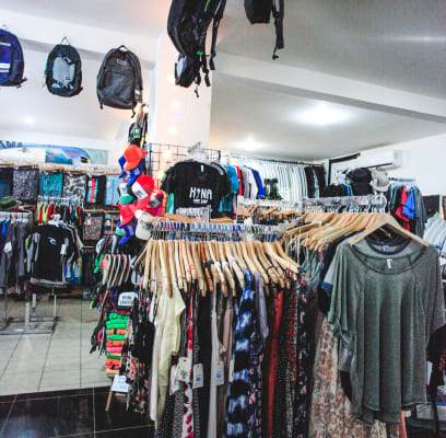 Clothing racks filled with casual wear inside a retail store.
