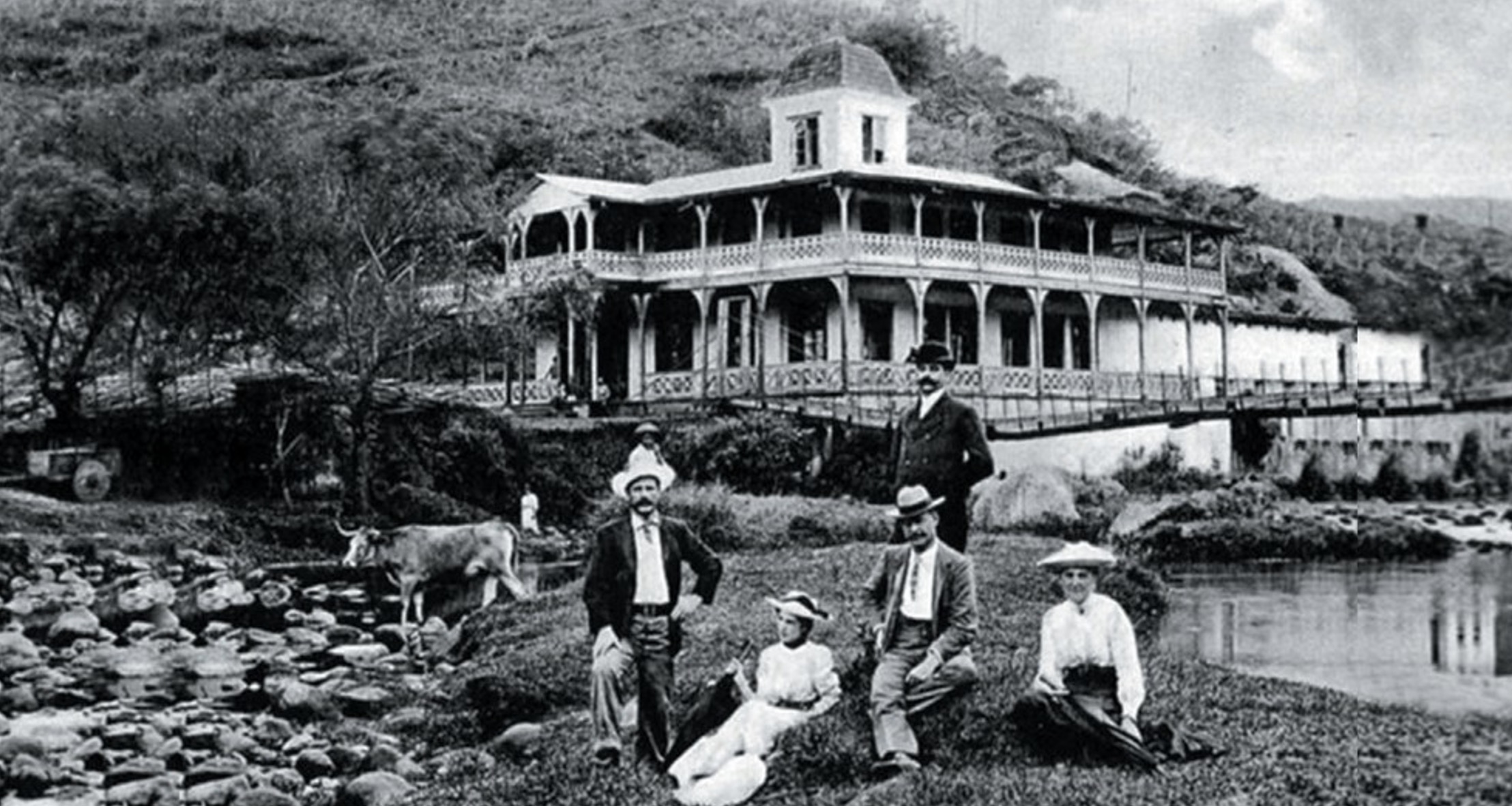 Historic castle-like building with a round tower and arched windows.