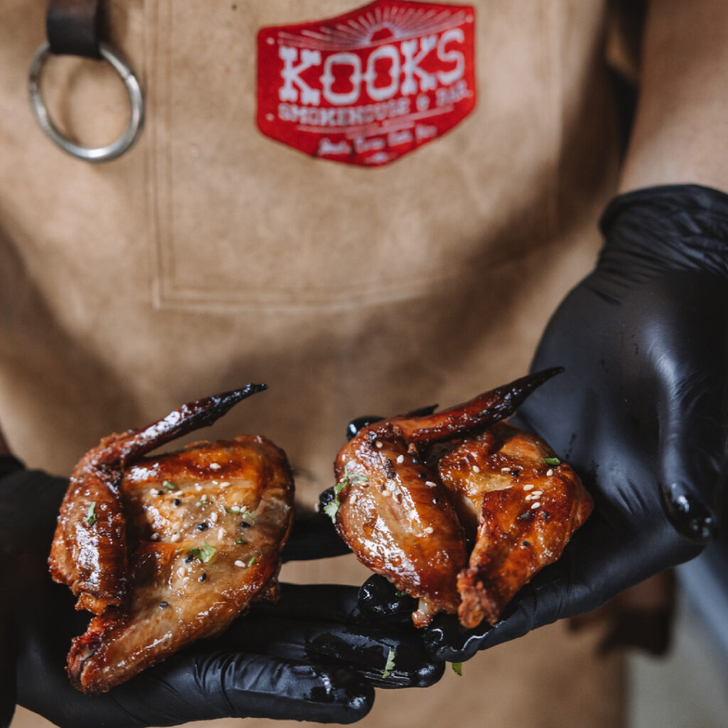 Sunset over a beach framed by palm trees.