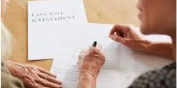 Older woman signing a Last Will and Testament with family member present in Costa Rica