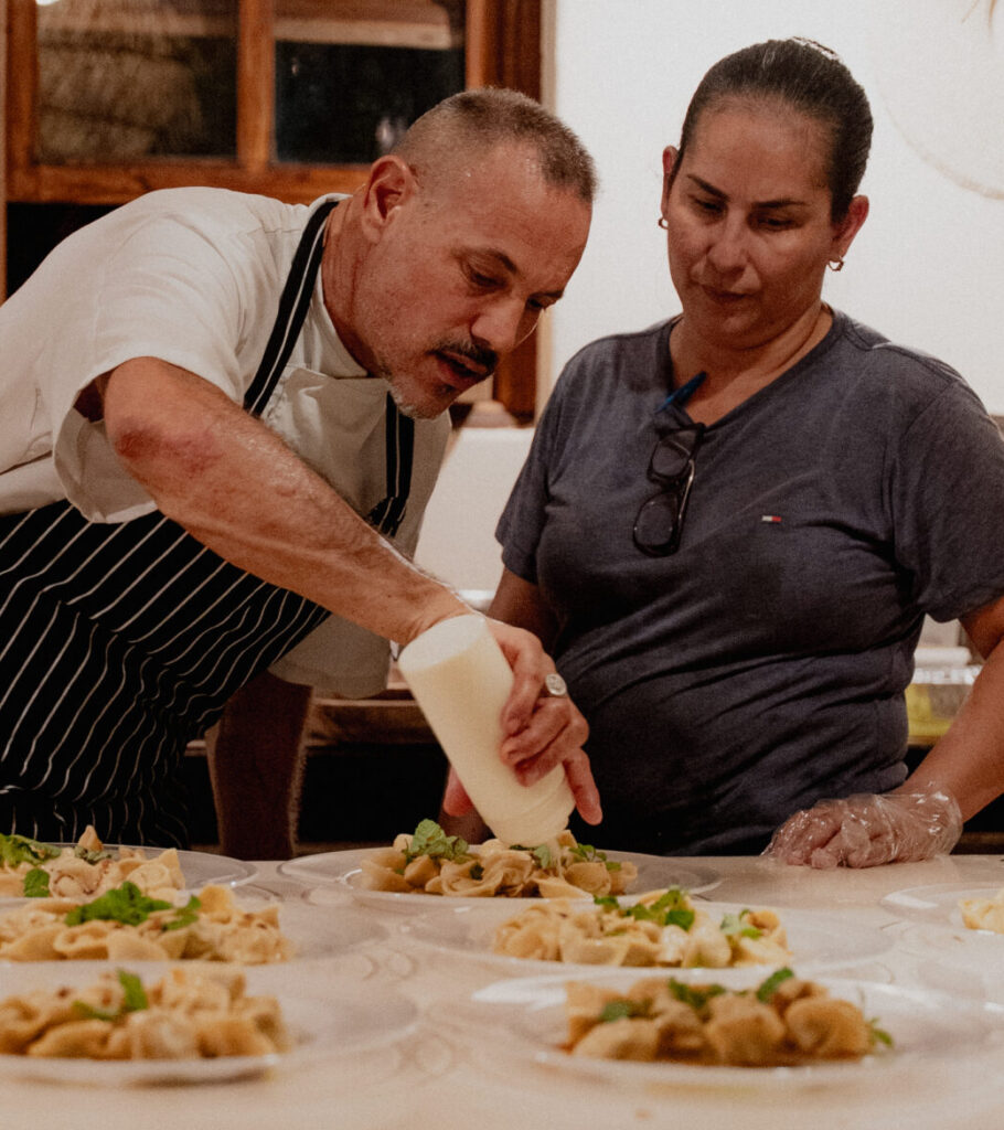 Chef and restaurant staff reviewing plated dishes in Santa Teresa Costa Rica