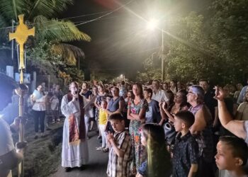 Good Friday Via Crucis procession at Iglesia Católica de Cóbano Costa Rica with community gathered in street service