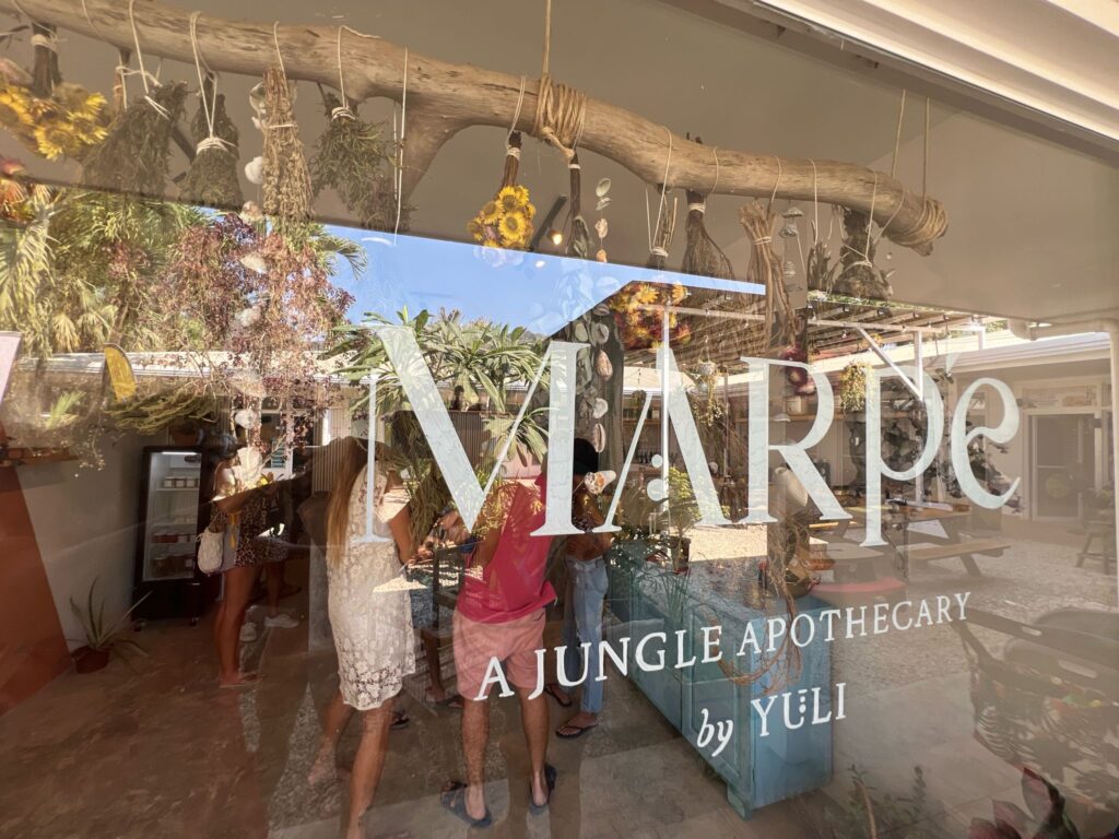 Glass storefront of Marpe Jungle Apothecary in Playa Carmen Santa Teresa Costa Rica showcasing a holistic wellness shop and herbal clinic