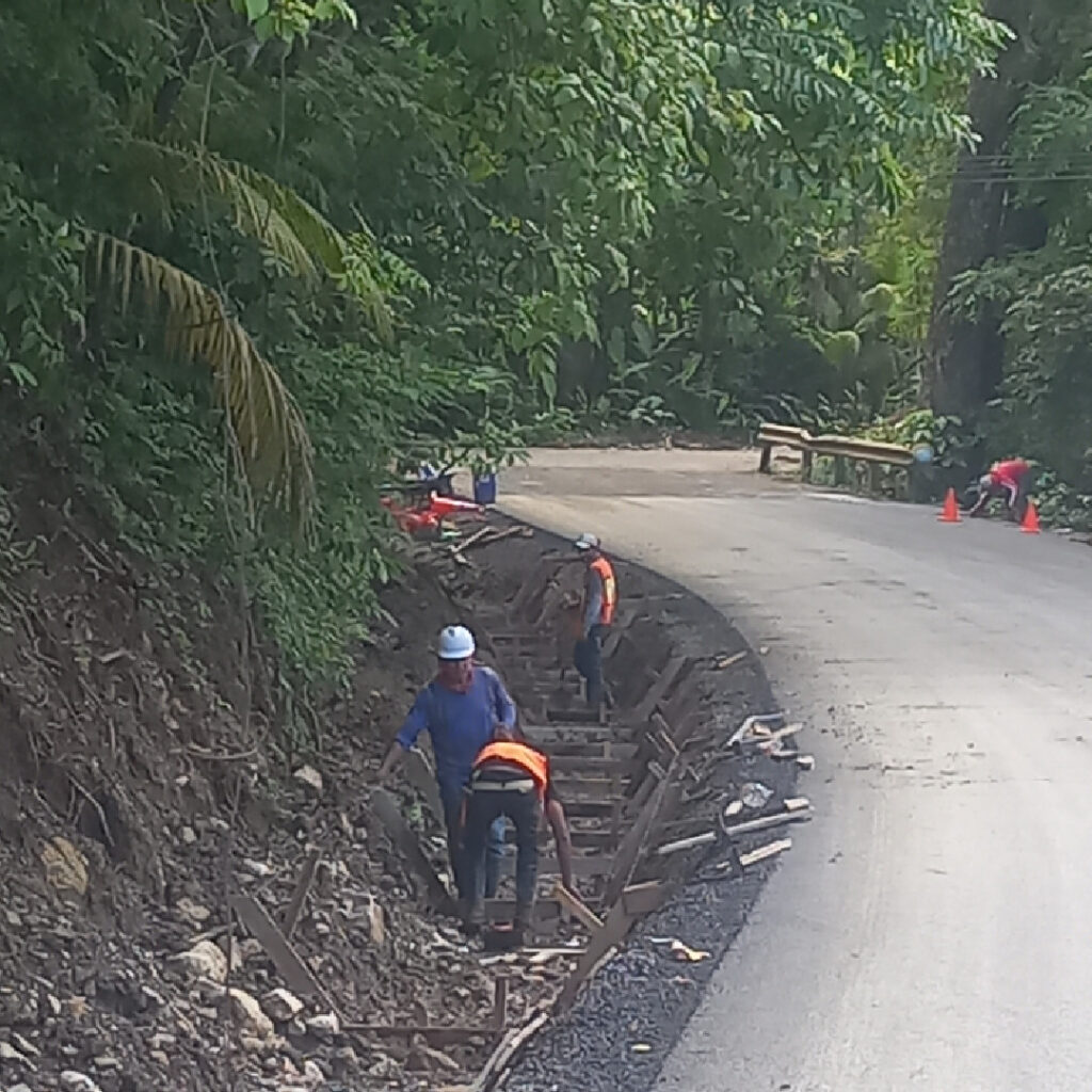 Construction crews building water drainage ditches along a newly improved road in Playa Hermosa, Puntarenas Province.