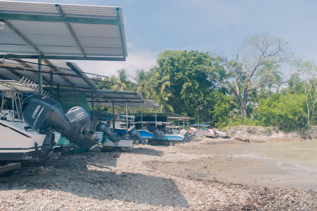 Malpais fishing village boats on shore Costa Rica fishermen filleting fish by the ocean