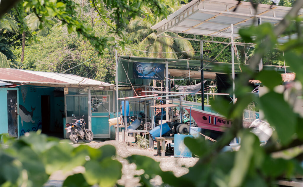 Malpais fishing village boats on shore Costa Rica fishermen filleting fish by the ocean