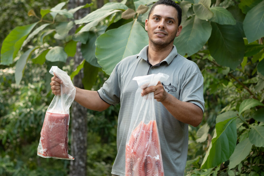 Tambor fishing cooperative fresh fish fillets Costa Rica fisherman holding bags seafood