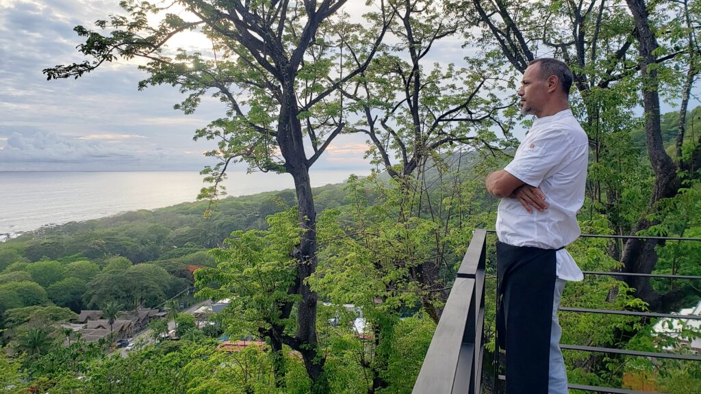Chef Eitan overlooking jungle and ocean from mountain deck in Santa Teresa Costa Rica