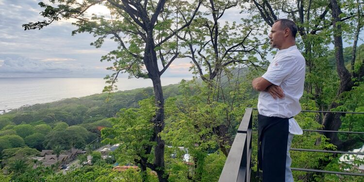 Chef Eitan overlooking jungle and ocean from mountain deck in Santa Teresa Costa Rica