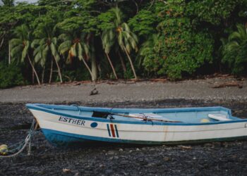 Traditional fishing boat resting at low tide in Malpaís Costa Rica during the early years before tourism transformed the coastline.