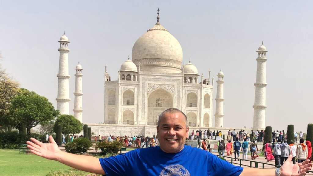 Alan standing in front of the Taj Mahal in India during his international travels.