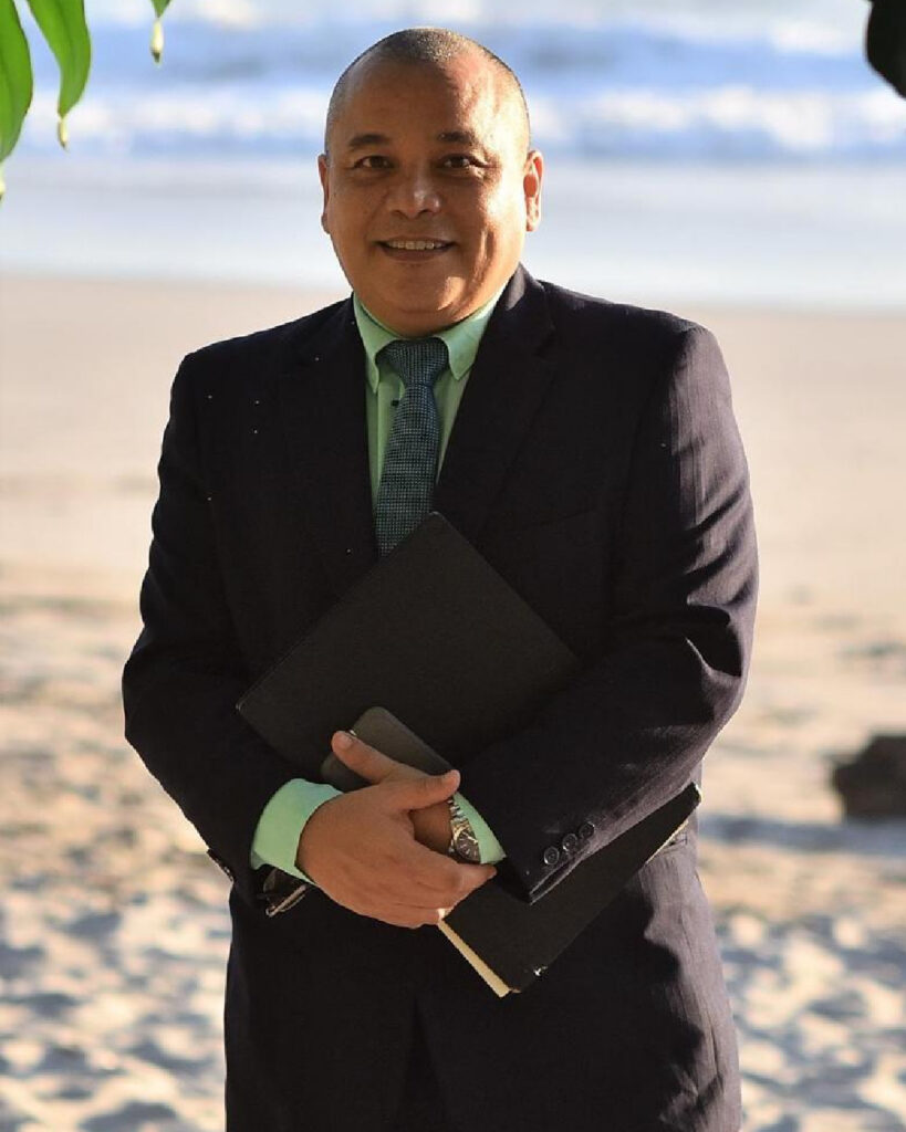 Alan wearing a suit and tie in a rare formal portrait, contrasting his well-known relaxed “barefoot lawyer” image in Malpaís, Costa Rica.