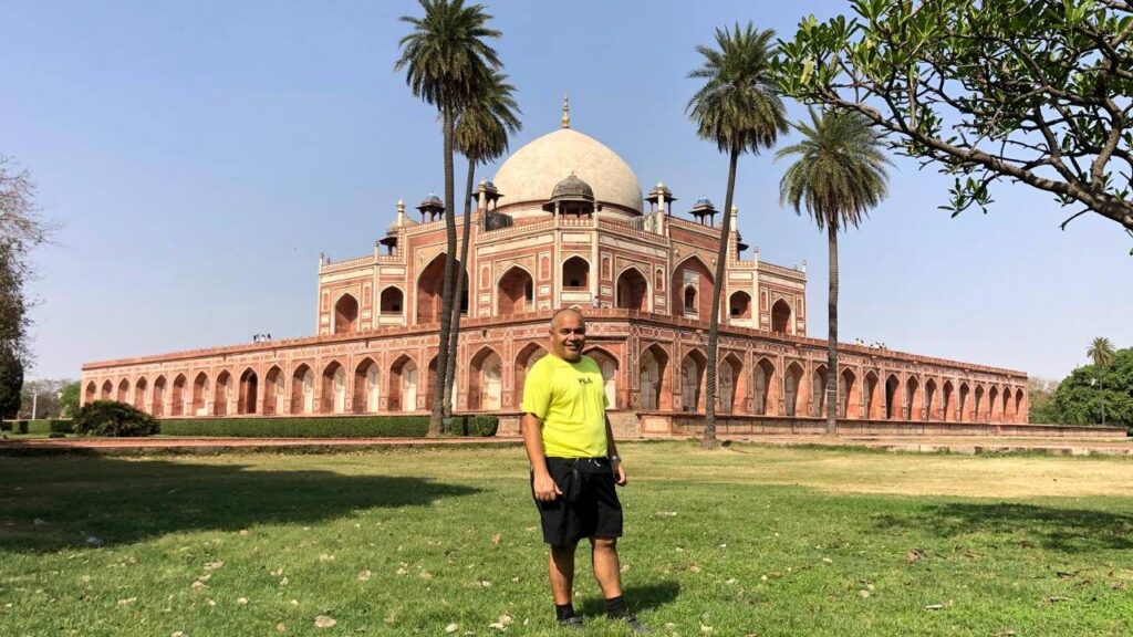 Alan standing in front of Humayun's Tomb in Delhi, India, during his travels exploring historic landmarks and world heritage sites.