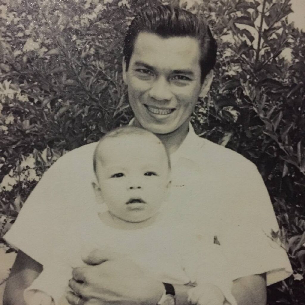 Baby Alan being held by his father in an early family photograph from Costa Rica.