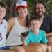 family from Atlanta relaxing on Santa Teresa Beach after their son discovered a fossilized Megalodon shark tooth during their Costa Rica vacation.